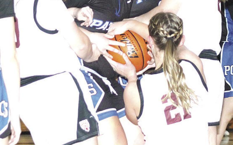 LHS’ Vivienne Johnsen (left), DeLanye Currie (right) and Maddie Janssen (#21, center) fight for a loose ball. Paula Jasa/Republican