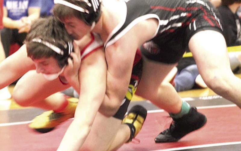 P.C.’s Jesse McLaughlin (on top) takes on a wrestler in the 165 lb. division at Districts. Photo provided by Jamie Maloley