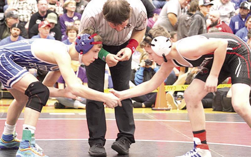 P.C.’s Luke Hunzeker (right) gets ready for his match in the 113 lb. division at Districts. Photo provided by Jamie Maloley