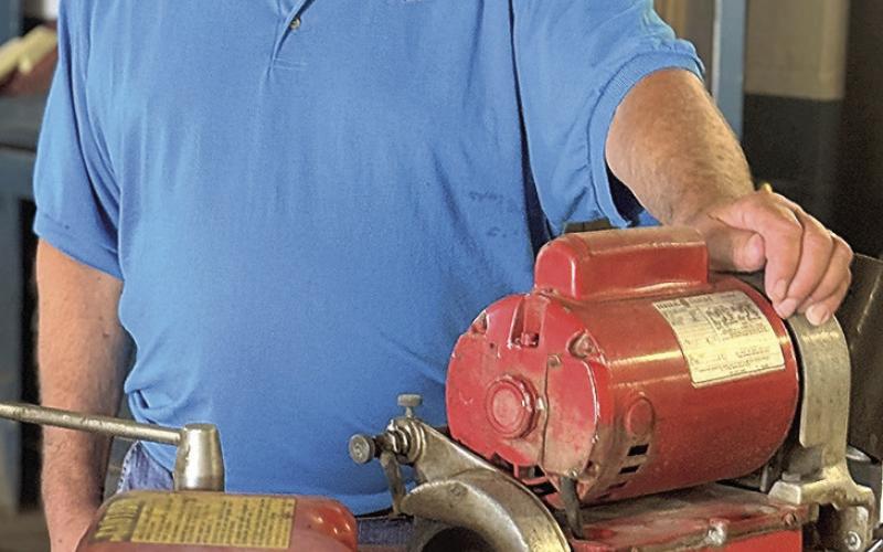 Randy Field with a valve grinder that has given faithful service. This item is on the auction and can be seen at the former Field Ford building in Tecumseh,