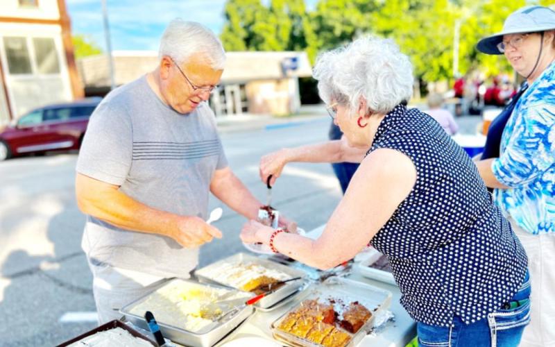 Arts Council board member Billie Kay Bodie of Burchard serves Larry Gilbert of Table Rock