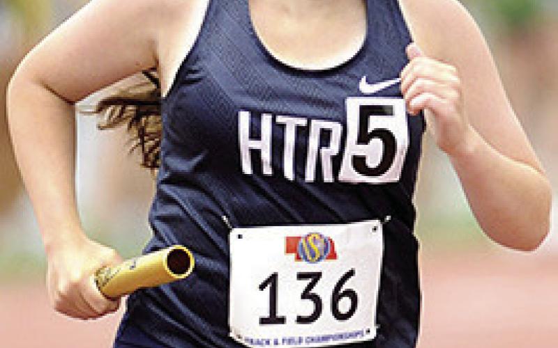 HTRS’ Eden Duryea takes her turn with the baton in the Class D girls’ 3200 M. relay on Friday. Photo courtesy of Luke Nichols/ Beatrice Daily Sun