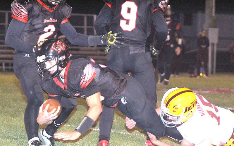 P.C.’s Philip Layne (#3, center) stretches for some extra yardage before halftime against Sterling on Friday night. Also pictured are Atreyu Kling (#2, left) and Jesse McLaughlin (#9). Pawnee City took care of Sterling by a 44-13 score. Paula Jasa/Republican