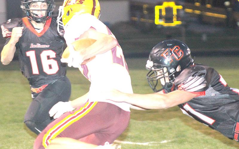 Pawnee City’s Wyatt Blank (right) goes for the tackle on a Sterling ball-carrier as Anthony Kling (#16, left) looks to help out. Paula Jasa/Republican