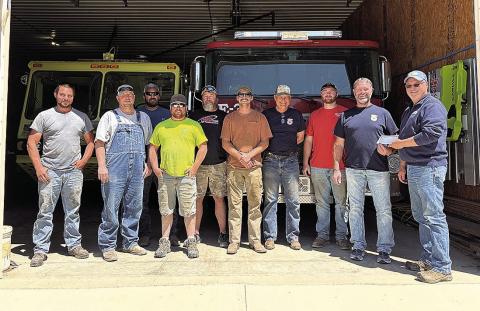 Jeff Wehrbein, Farmers Cooperative Burchard Location Manager presents grant check to DuBois Fire Department members.