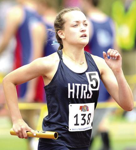 HTRS’ Grayson Sherman runs her leg of the Class D girls’ 3200 M. Relay on Friday. The Lady Titans made it to the podium with their school record time of 10:15.56. Photo courtesy of Luke Nichols/Beatrice Daily Sun