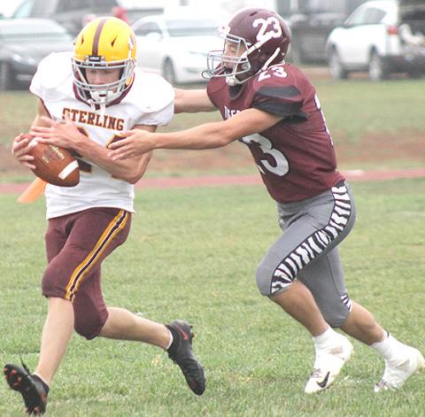 LHS’ Kaden Wagner (#23, right) makes a good tackle on a Sterling runner. Wagner had some great stops in the game including a touchdown-saving tackle. Paula Jasa/Republican