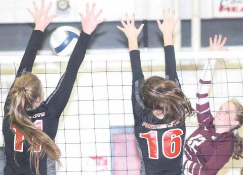 P.C.’s Madison Branek (#11, left) and Reyana Tegtmeier (#16, right) team up at the net against Sterling in Thursday night triangular action. Paula Jasa/Republican