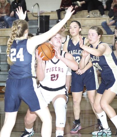 LHS’ Maddie Janssen (#21, center) goes up in high traffic in the lane against Omaha Christian Academy on Saturday. Janssen scored 9 points in the Lady Tigers’ 3735 comeback triumph over OCA and went to the free throw line several times. Paula Jasa/Republican
