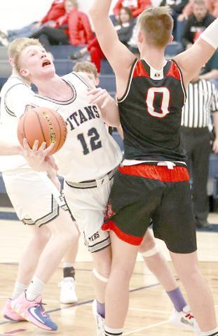 HTRS’ Brogan Dunlap (#12, center) drives the paint against Wymore Southern in the Titans’ home game on Saturday, December 17th. The Titans lost to the Raiders by a 39-71 score. (Individual statistics were not available at the time of printing.) photo courtesy of Lorrie Novak