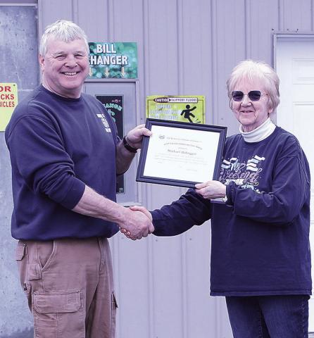 Lola Seitz (right) presents Mike Habegger (left) with the Carolyn VanHorne Civic Award