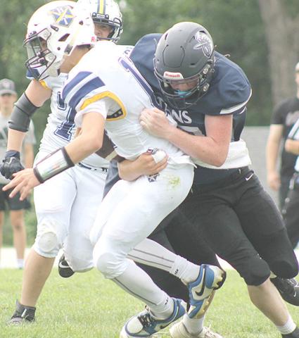 HTRS’ Colt McClarnen (#27, right) sacks the Omaha B-T quarterback on Saturday. McClarnen had 3 tackles and 1 sack in the 70-64 victory over the Raiders. Paula Jasa/Republican