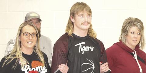 LEWISTON PARENTS’ NIGHT - Tristen Ray is accompanied by his parents prior to the Lewiston vs. Sterling boys’ game on Friday night.