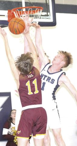 HTRS’ Brogan Dunlap (#1, right) gets his hand on a block against a Sterling shooter on Friday night. Paula Jasa/Republican