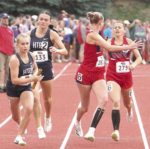 HTRS’ Miranda Rist (left) takes the handoff from teammate Lillian Bowen (#133) in the Class D girls’ 1600 M. Relay on Saturday. Photo courtesy of Stephanie Croston/Seward County Independent