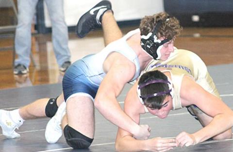 HTRS/P.C’s Andy Maloley dominates his Louisville opponent at the Titan’s home double dual on Thursday. Paula Jasa/Republican