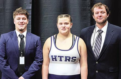 photo by Lorrie Novak Ava Grimes, HTRS Wrestling Team, poses with coaches Aiden Worthey (left) and Ryan Worthey (right). Ava competed at the State Wresting Tournament. Story on page 6.