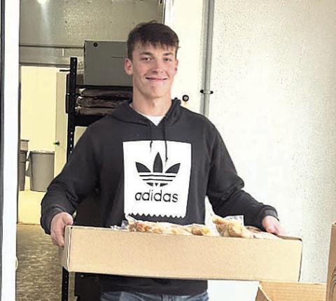 Eli Boellstorff of Auburn exits freezer with part of customer’s processing order