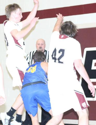LHS’ Caleb Rule (left) and Ethan Horne (#42, right) team up on defense on the baseline against T-C. Paula Jasa/Republican