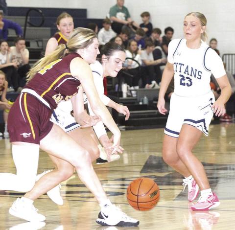 HTRS’ Lillian Bowen (center) goes for a loose ball against Sterling as teammate Jaylie McNealy (#23, right) looks to help out. The Lady Titan defeated the Lady Jets on Friday night by a 48-38 score. Paula Jasa/Republican