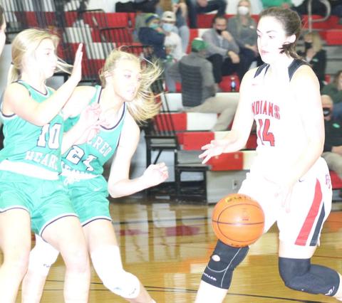 P.C.’s Reyana Tegtmeier (#14, right) gets double teamed by FCSH Lady Irish defenders as she brings the ball down the court on Friday night. Paula Jasa/Republican