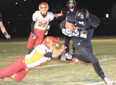 P.C.’S Kyle Gyhra (#22, right) keeps a handle on the ball while busting through tackles on this 45 yard touchdown run in the 2nd quarter. Paula Jasa/Republican