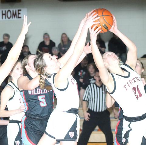Paula Jasa/Republican LHS’ Carleigh Weyers (center) and Madeline Janssen (#21, right) fight for a rebound in the early going against Cedar Bluffs. Lewiston won easily, 66-16.