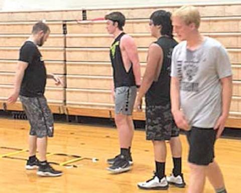 Working on summer conditioning at Lewiston are from left, Coach Kyle Asche, Hayden Christen, Cayd Wilgers, and Jon Janssen