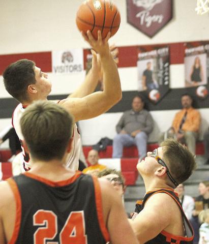 Paula Jasa/Republican P.C.’s Anthony Kling (left) soars through the lane past two Diller/Odell defenders. Kling amassed 30 points against the visiting Griffins in the Indians’ 57-40 victory.