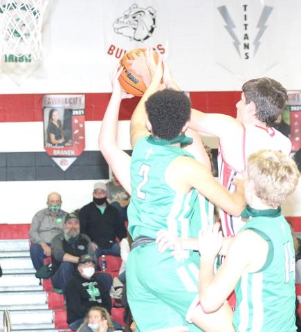 P.C.’s Bryce Gyhra (above, center) fights for a rebound against FCSH as teammate Kyle Gyhra (#10, right) drives the ball down past the Irish in Friday night’s home game. photos by Paula Jasa/Republican