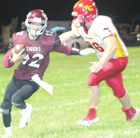 Lewiston’s Abel Gonzalez (#12, left) avoids a Red Cloud tackler on his way to the end zone. Paula Jasa/Republican