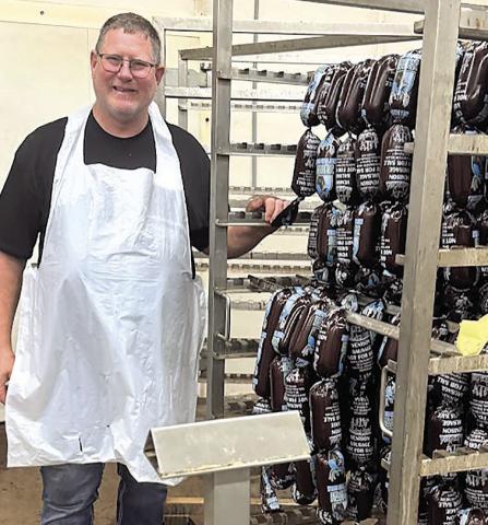 Den Schaardt with 400 pound cart of deer sausage headed for smoker.