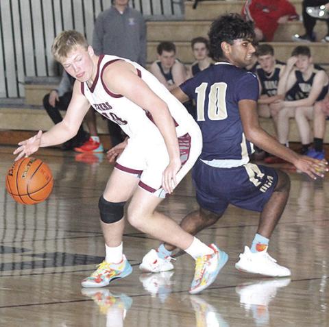 LHS’ Everett Bohling (#10, left) fakes out his OCA opponent on his way down the court. Bohling scored 20 points to lead the Tigers in Saturday’s game. Paula Jasa/Republican