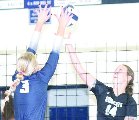HTRS’ Macy Vrtiska (#3, left) gets her hands on a block against the E-M-F Bobcats at the Pioneer. Paula Jasa/Republican