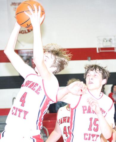 P.C.’s Kylenn Koester (#4, left) pulls in a late rebound as teammate Kaden Lang (#15, right) looks on. Paula Jasa/Republican