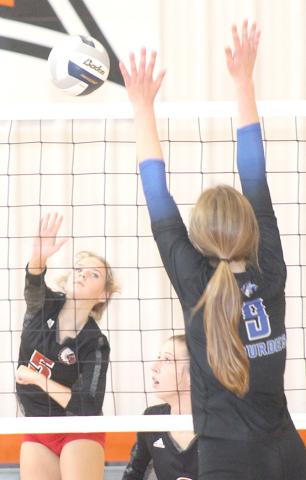 Paula Jasa/Republican P.C.’s Madison Fender (#5, left) launches a spike past a Nebraska City Lourdes defender in the Pioneer Conference 3rd place game on Saturday.