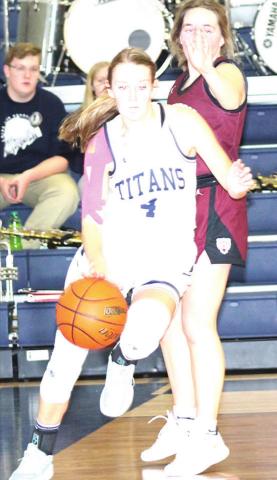 Paula Jasa/Republican HTRS’ Gracie Shafer (#4) drives the baseline against LHS’ Carleigh Weyers in Tuesday night’s game.