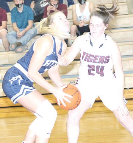 HTRS’ Katilyn Glathar (#3, left) goes up for a shot under the bucket against LHS’ Carleigh Weyers (#24, right). Glathar scored a single game school record of 32 points in the game against Lewiston last week. Paula Jasa/Republican