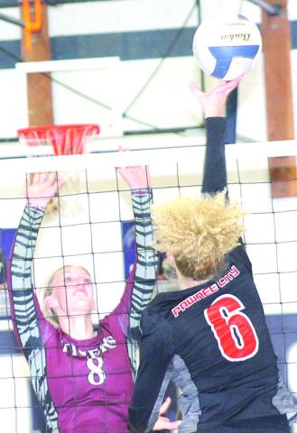 P.C.’s Madelyn Osborne (#6, right) goes up for a tip over LHS’ Maddie Janssen (#8, left) at the Pioneer. Paula Jasa/Republican