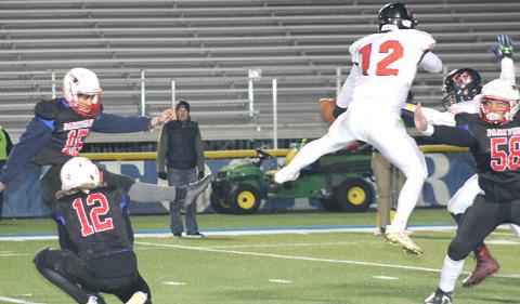 Pawnee City’s Andy Maloley (#12, center) blocks a PAT kick late in the game against Parkview Christian. Paula Jasa/Republican