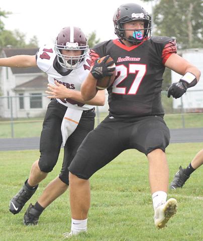 P.C.’s Joey Marteney (#27, right) swivels past LHS’ Caleb Rule (#14, left) on his way to score a touchdown. Paula Jasa/Republican