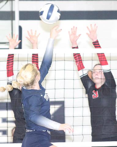 HTRS’ Elie Bstandig (center) goes up and over the Lady Mustang defense on Thursday. Bstandig had 13 kills, 2 solo ace blocks and 1 assisted block at the net. Paula Jasa/Republican