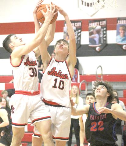 P.C.’s Jett Farwell (#30 left) and Drew Menninga (#10, right) battle for a rebound against Palmyra last Thursday night. Paula Jasa/Republican