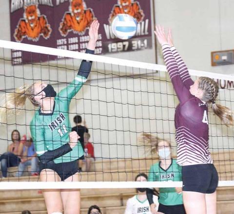LHS’ Emma deKoning (#4, right) goes up for an ace block against Falls City Sacred Heart in Thursday night action. LHS lost the match in three sets. Paula Jasa/Republican