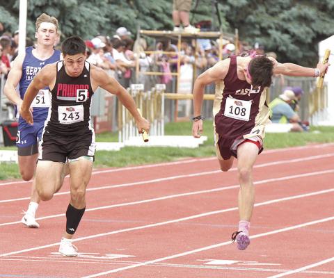 Pawnee City’s Anthony Kling (center, #243) crosses the finish line just ahead of two other runners in the Class D boys’ 400 M. relay. P.C. finished 7th with a time of 44.65. Photo courtesy of Stephanie Croston/Seward County Independent