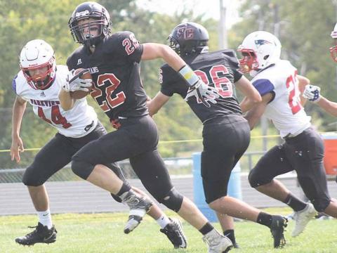 Pawnee City’s Kyle Gyhra (#22) scores the first touchdown of the game as teammate Bryce Gyhra (#26) helps pave the way. Paula Jasa/Republican