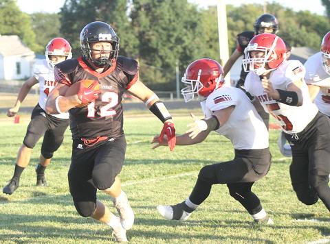 Pawnee City’s Andy Maloley (#12, left) eludes several Franklin tacklers on his way for a big gain in the first half. Pawnee City won their home opener easily, 48-7. Paula Jasa/Republican