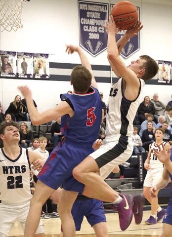 HTRS’ Brennen Vaughan (center) gets fouled on an offensive rebound and putback try at the end of the game as teammates Hunter Bohling (#22, left) and Emmett Glathar (#11, right) look on. HTRS lost a close one to Palmyra 46-53 last Thursday night. Paula Jasa/Republican