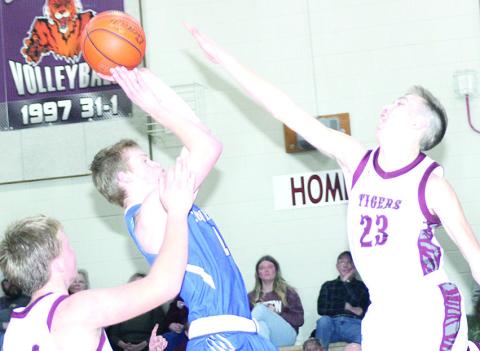 LHS’ Ashton Sanders (#23, right) and Caleb Rule (left) defend against a Cornerstone Christian player in the lane on Friday night. Lewiston lost a close game, 54-59. Paula Jasa/Republican