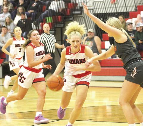 P.C.’s Maddy Osborne (center) drives the paint against Diller/Odell on Thursday night as teammates Kinsley Benson (#3) and Cameron Ottersberg (#4) look on. Paula Jasa/Republican